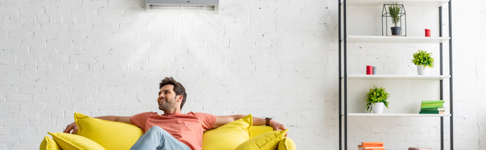 Panoramic,Shot,Of,Handsome,Man,Sitting,On,Yellow,Sofa,Under