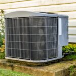 An,Air,Conditioner,Sitting,On,A,Concrete,Pad.,This,Is