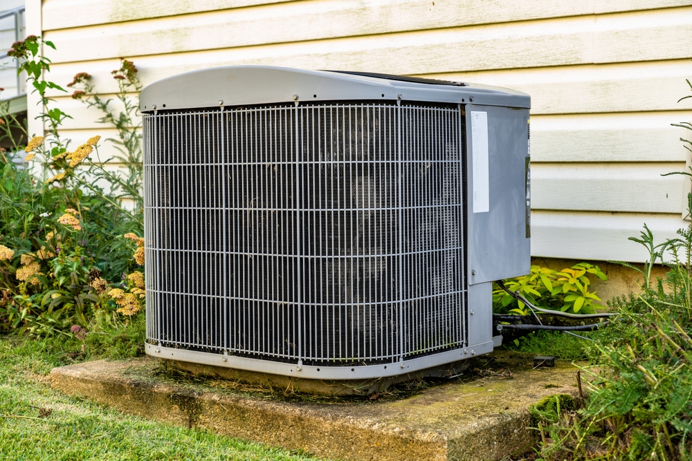An,Air,Conditioner,Sitting,On,A,Concrete,Pad.,This,Is